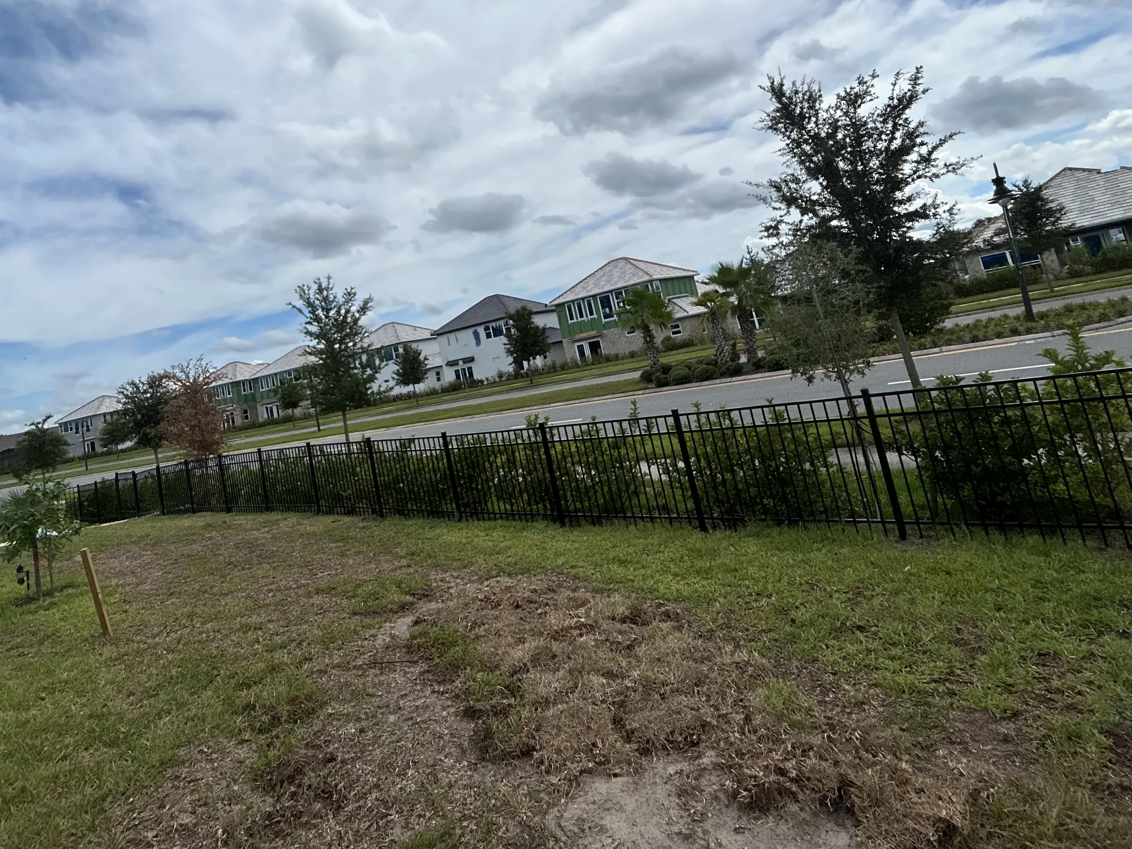Black aluminum fence installed along a residential property